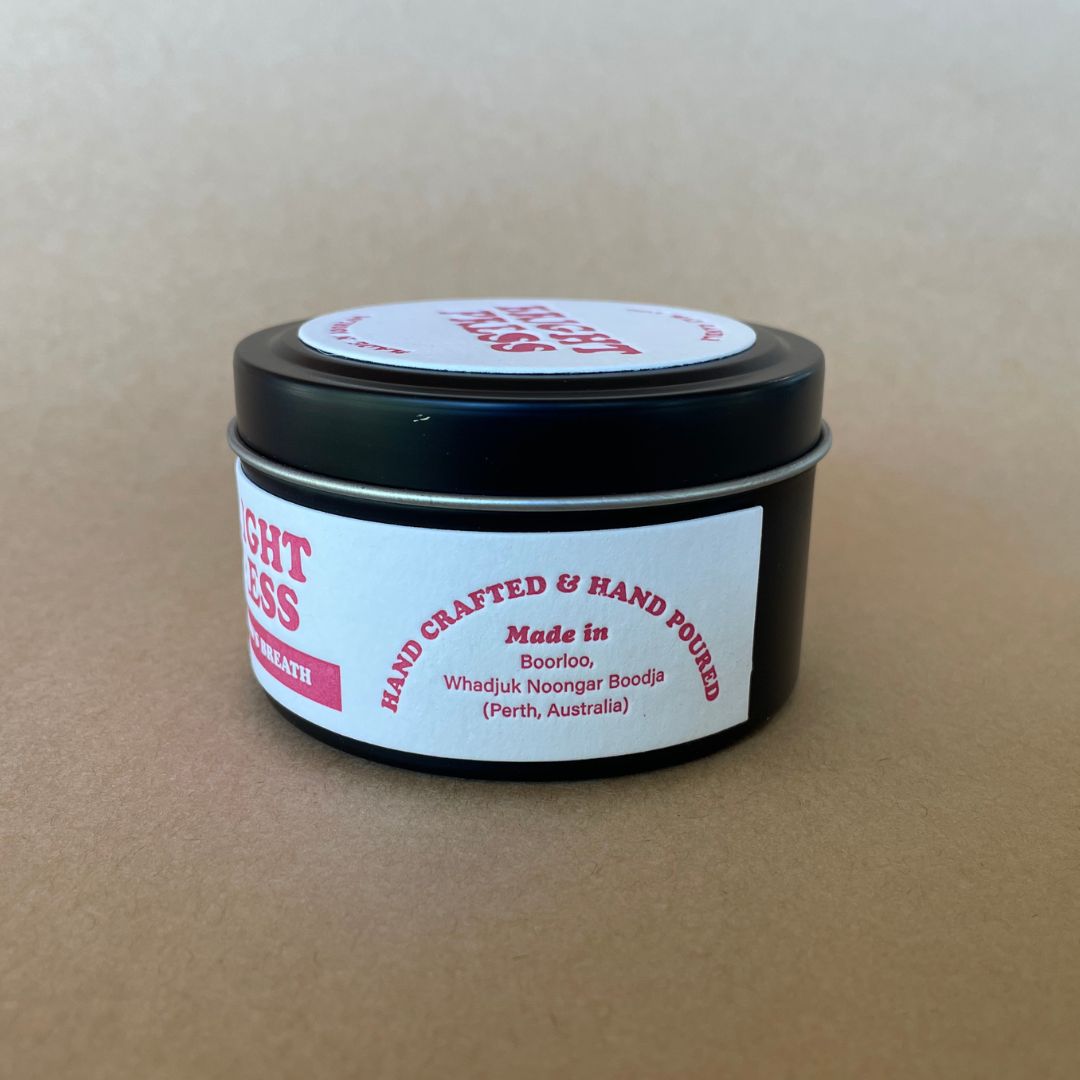 Side view of Dragon's Breath Soy Wax Candle featuring the maker's details