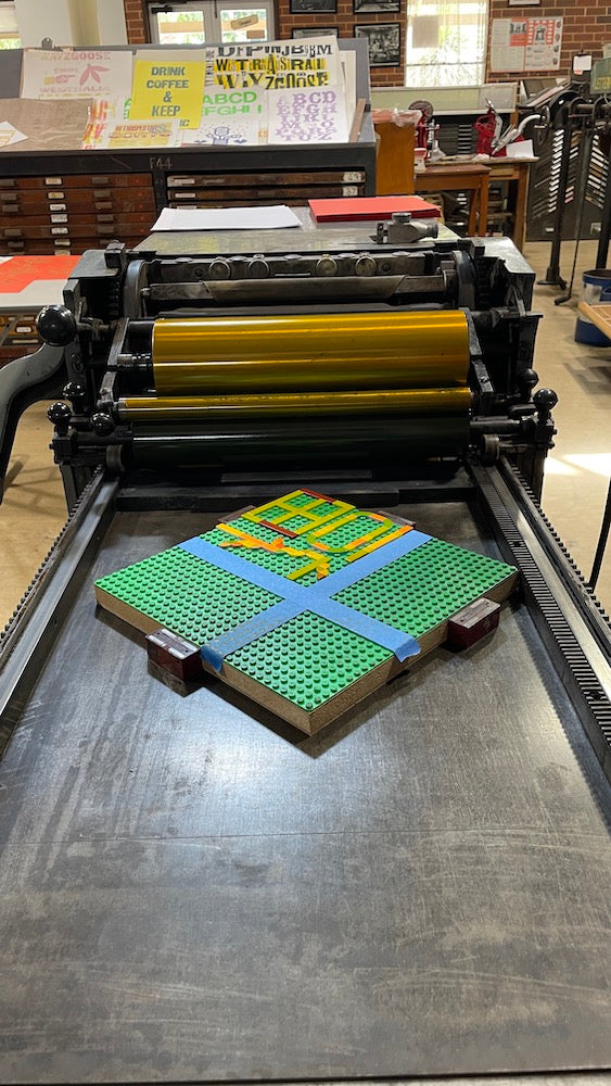 Work in progress image of the lego tile design on the vintage printing press ready to be printed.