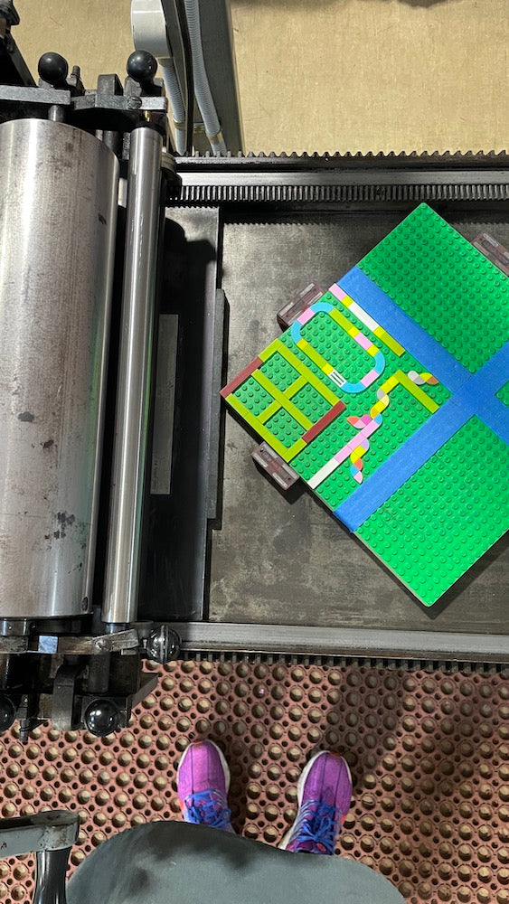 Bird's eye view of the lego tile design on the printing press.