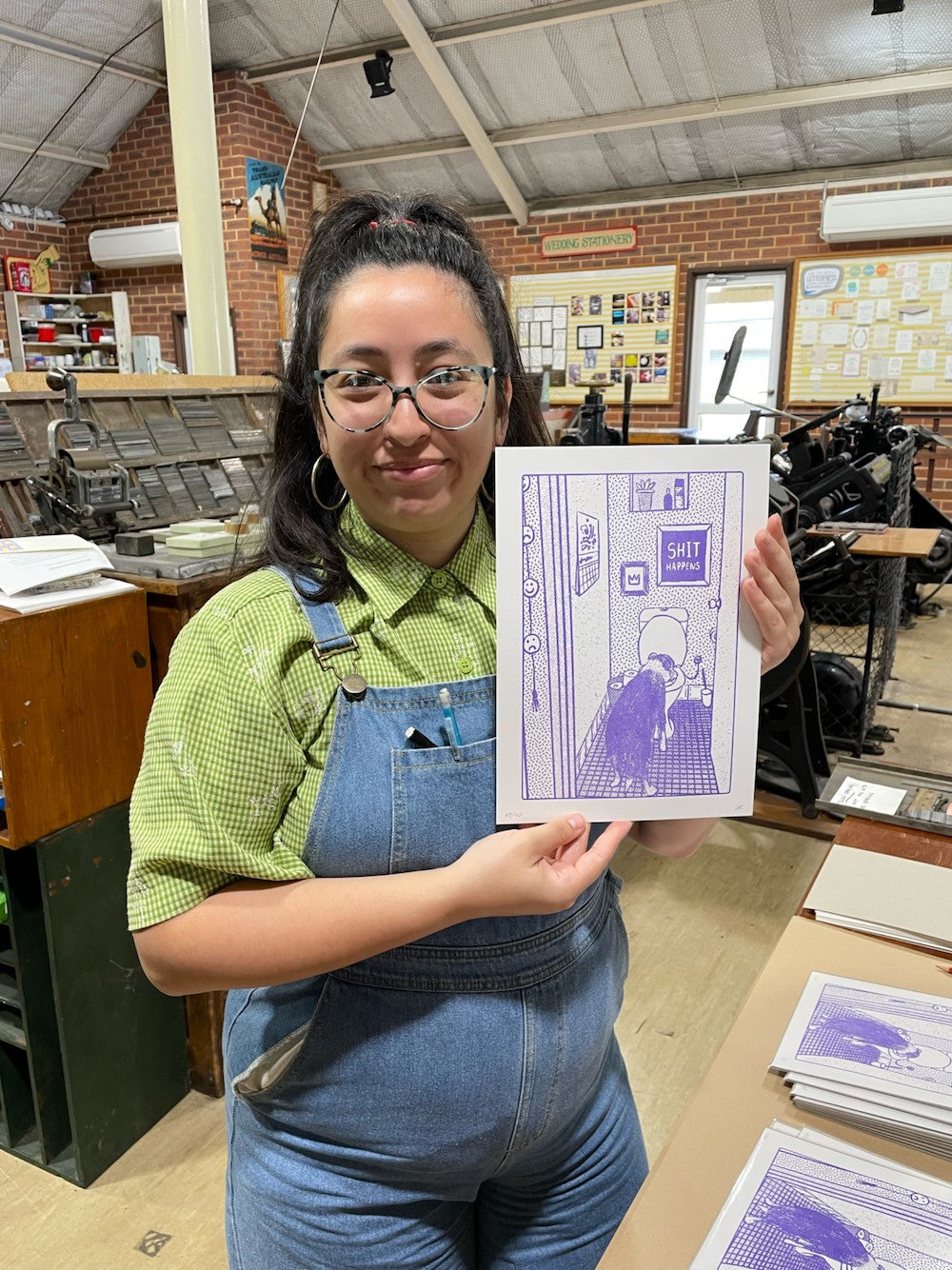 Ophelia Roberts of Banksia Creative posing with a freshly editioned print