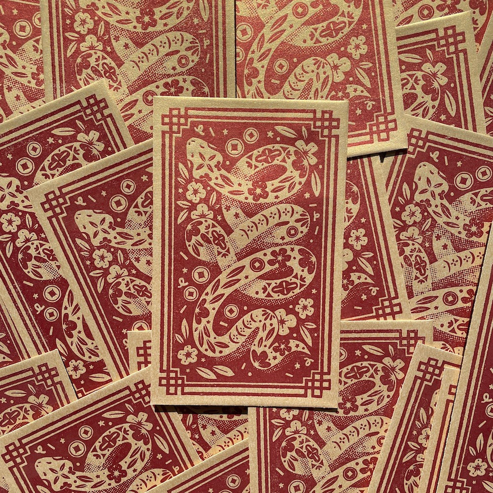 Many Year of the Snake Red Packets in a flatlay heap